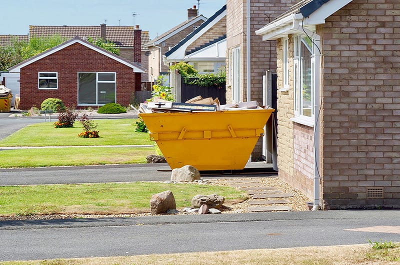 mini-skip-outside-house