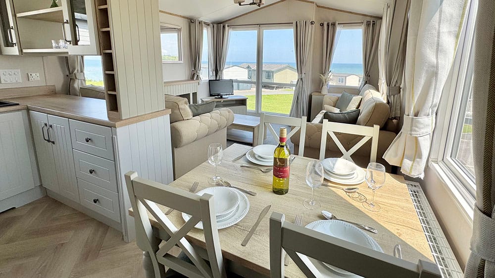 atlas-debonair-dining-area-4994 View from inside a static caravan across the sea at Bron-Y-Wendon Holiday Park