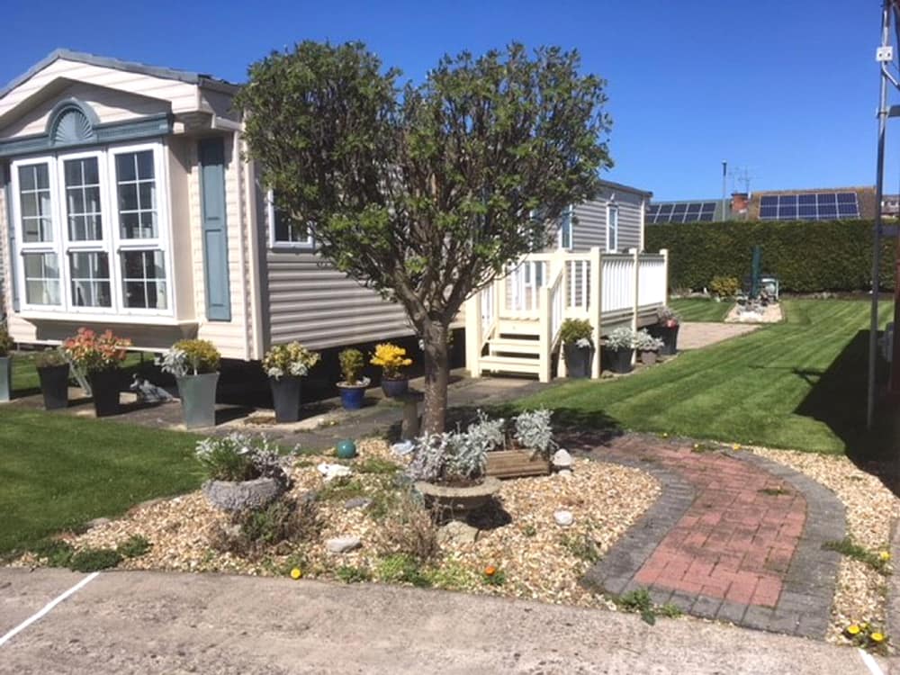 Heart shaped tree in front of a caravan at Pentre Mawr Caravan Park