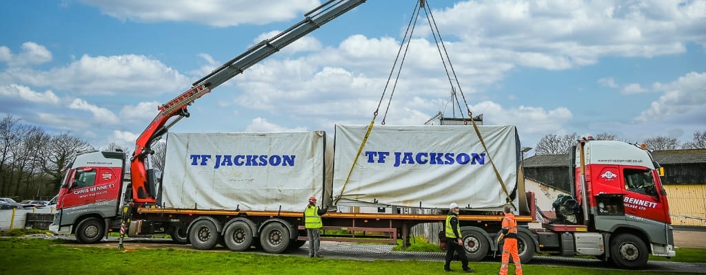 Two TF Jackson modular buildings on the back of a truck, ready to be lifted off by crane