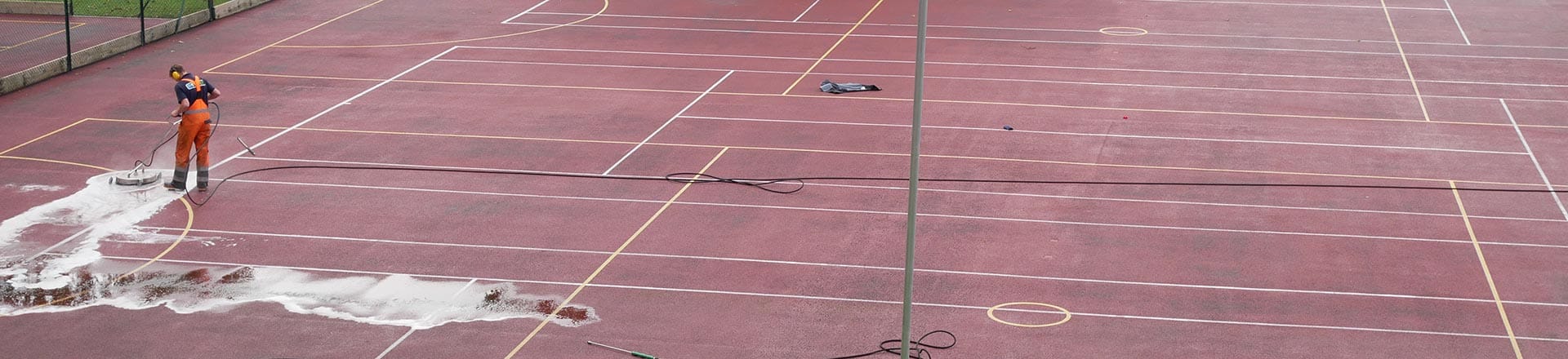 man cleaning sports pitch