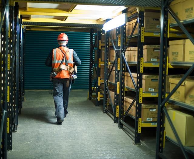 man walking amongst secure storage boxes