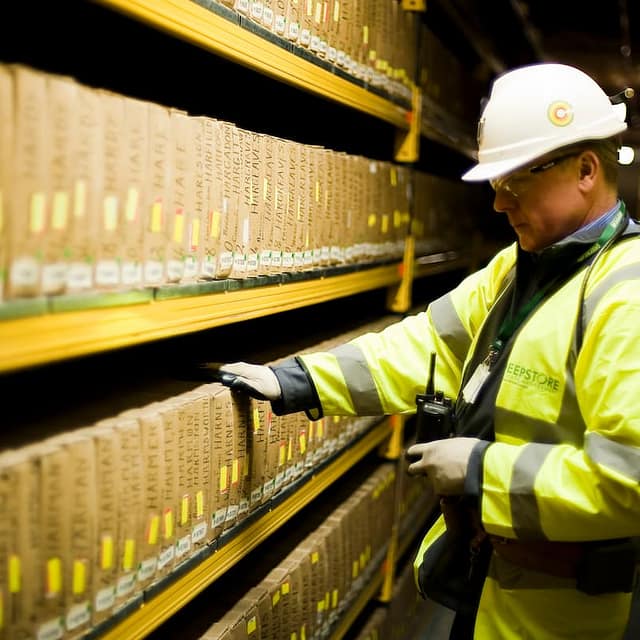 Deepstore employee safeguarding assets down a corridor