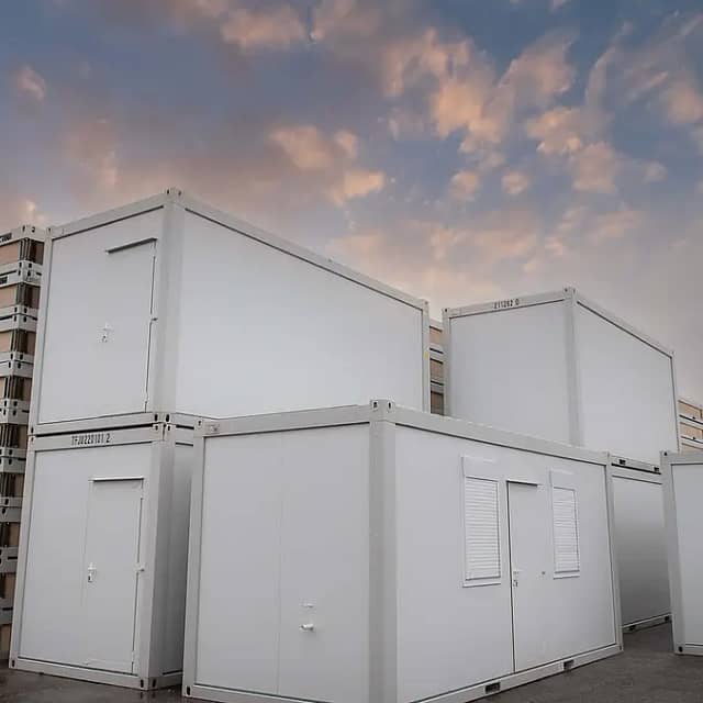 Stacked and single modular units at twilight with a dramatic sky of pink and blue clouds