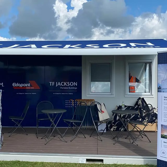 T.F. Jackson branded trade show stand featuring portable buildings, under a partly cloudy