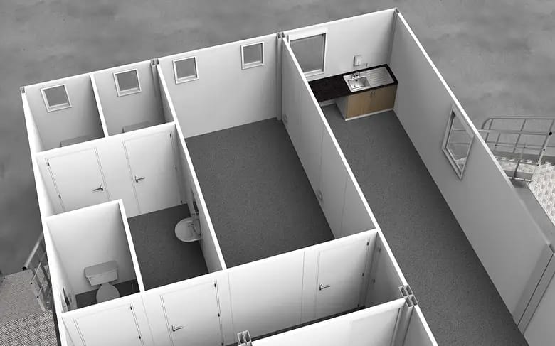 Interior view of a modular building showing partitioned rooms with a kitchenette and a restroom
