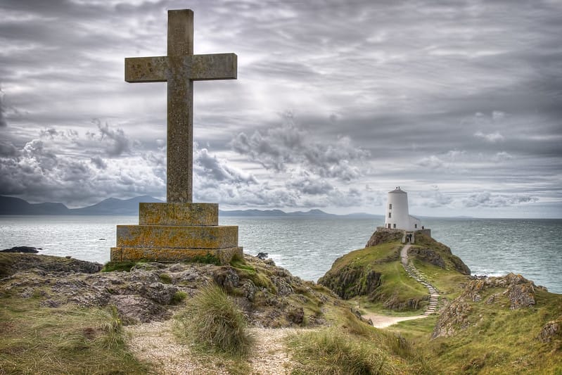 Saint Dwynwen's Cross with Twr Mawr Lighthouse close behind