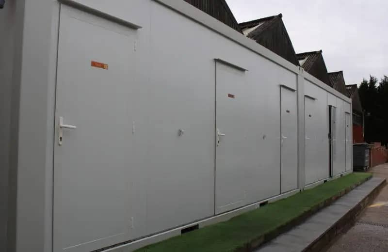 Long modular building with multiple doors.