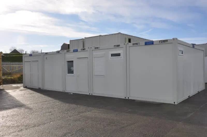 Large modular building complex on a paved lot with various compartments and air conditioning units