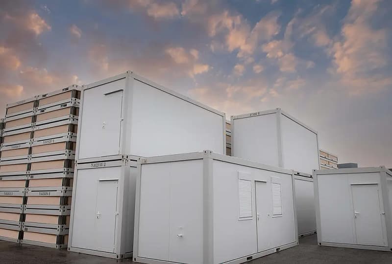 Stacked and single modular units at twilight with a dramatic sky of pink and blue clouds