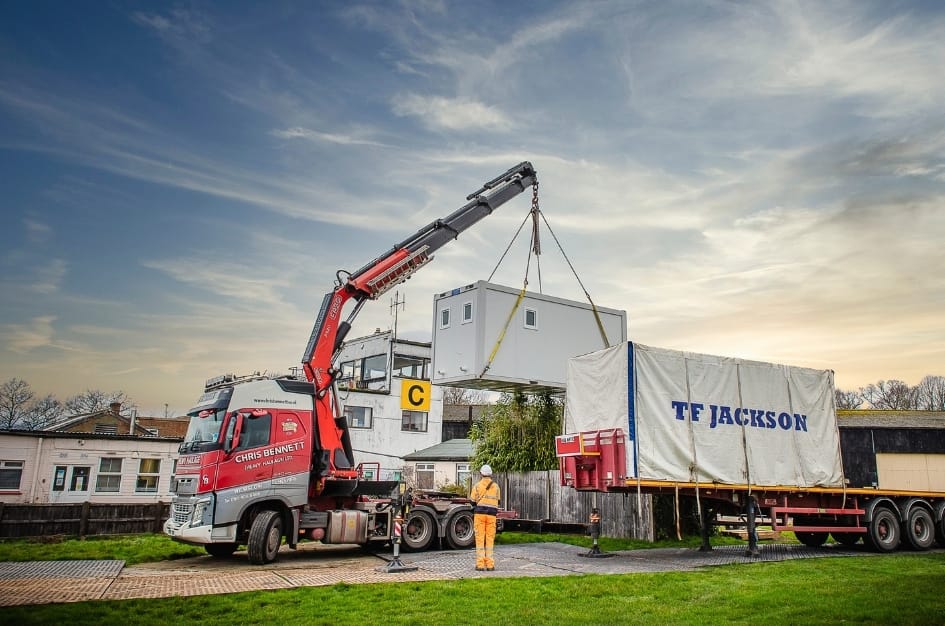 TF Jackson offloading the units by crane that will comprise Fairoaks Airport's new terminal building