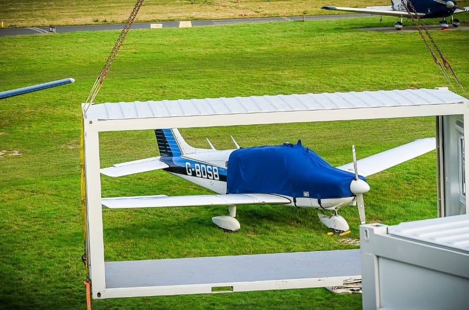 A small propellor plane, photographed through a TF Jackson modular building shell