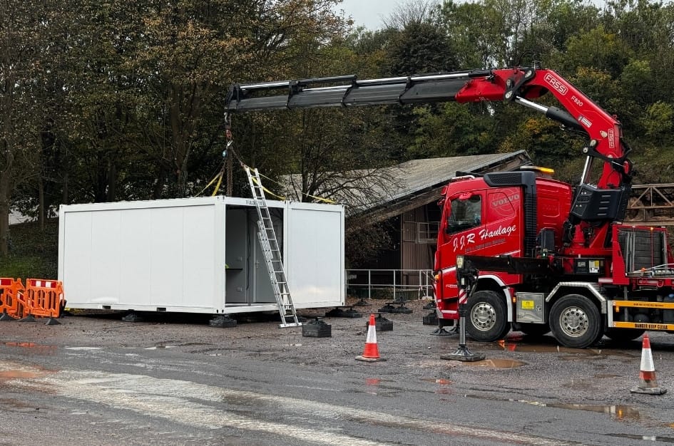 The first unit of a prefabricated building freshly crane-lifted into place